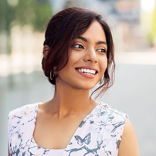 young woman with big smile outside